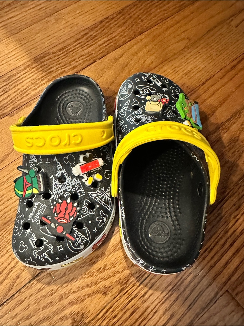 CROCS Kids Black Printed Clogs with Yellow Strap and Character Jibbitz